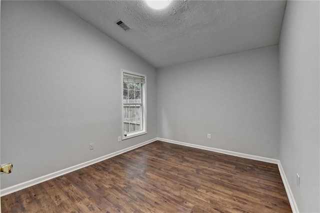 1965 Sterling Creek Ct, Snellville, GA 30078 - spare room featuring vaulted ceiling, baseboards, dark wood-style flooring, and a textured ceiling