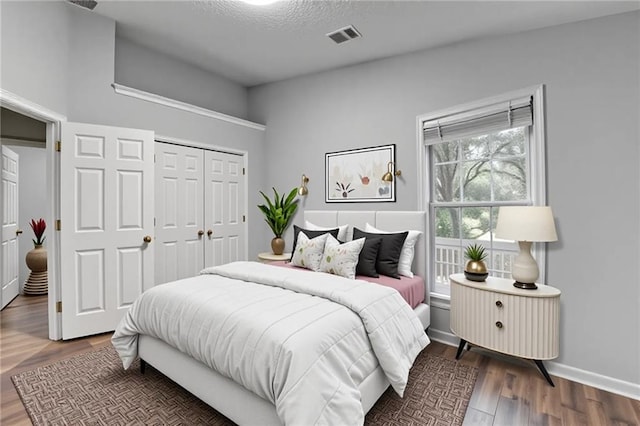 1965 Sterling Creek Ct, Snellville, GA 30078 - bedroom featuring wood finished floors, a closet, and a textured ceiling