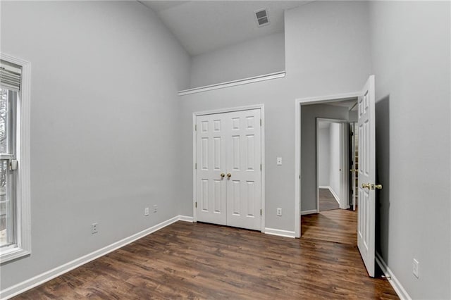 1965 Sterling Creek Ct, Snellville, GA 30078 - unfurnished bedroom with baseboards, dark wood-style floors, a closet, and high vaulted ceiling