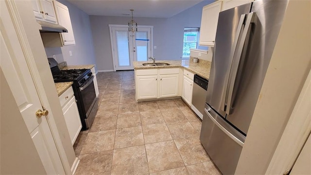 kitchen featuring pendant lighting, sink, white cabinetry, kitchen peninsula, and stainless steel appliances