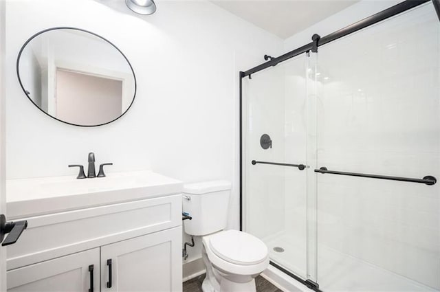 bathroom featuring vanity, toilet, and walk in shower