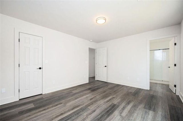 empty room featuring dark hardwood / wood-style flooring