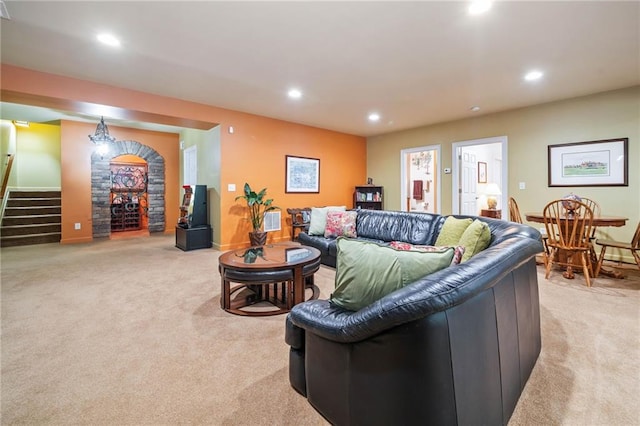 living area with light carpet, recessed lighting, stairway, and baseboards