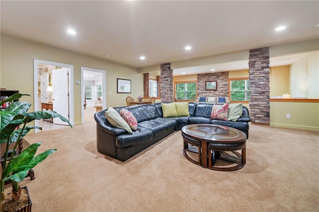 carpeted living area with decorative columns, recessed lighting, and baseboards