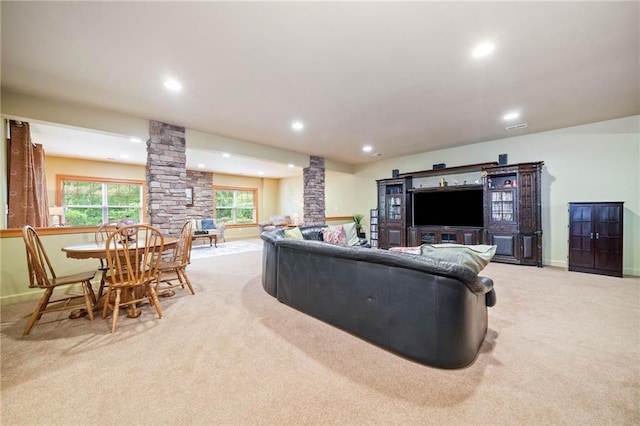 living room featuring decorative columns, light colored carpet, recessed lighting, and baseboards