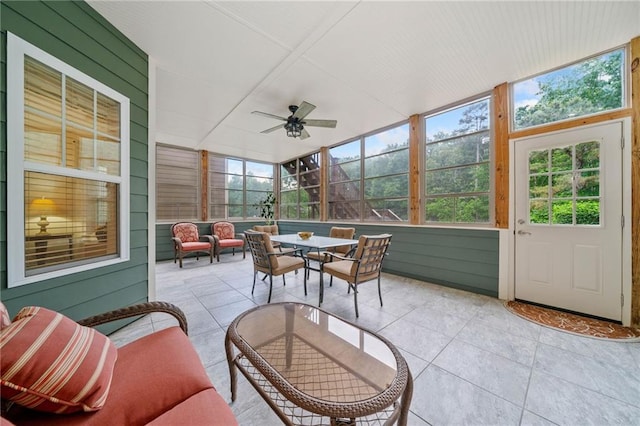 sunroom / solarium featuring ceiling fan, an outdoor hangout area, and outdoor dining space
