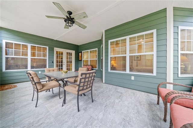 view of patio with a ceiling fan, outdoor dining area, and french doors
