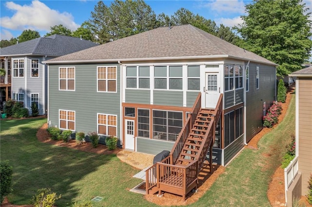 rear view of property featuring stairs, a lawn, and roof with shingles