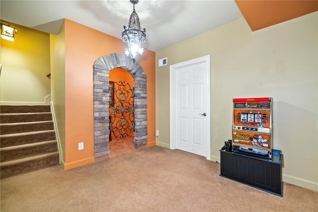 game room with carpet flooring, arched walkways, and baseboards