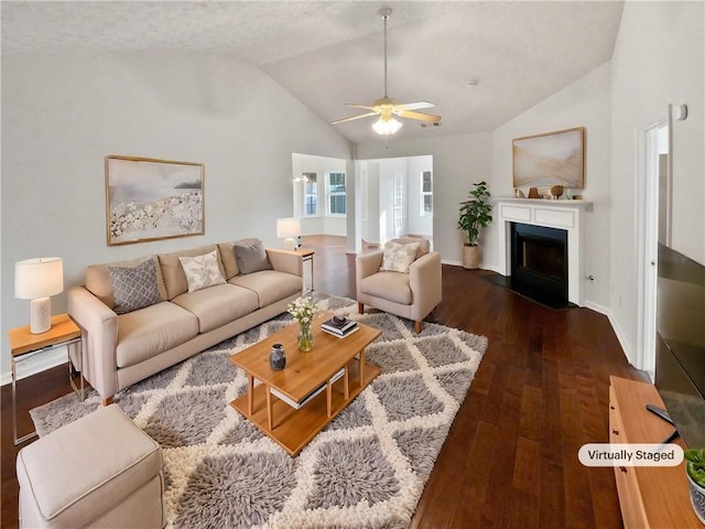 living room with lofted ceiling, dark hardwood / wood-style floors, and ceiling fan