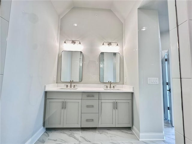 bathroom featuring a sink, baseboards, and marble finish floor