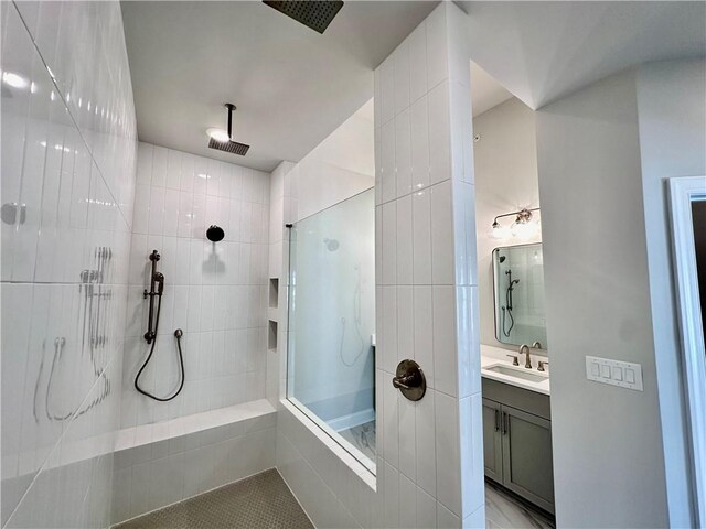 full bathroom featuring tile patterned flooring, a walk in shower, and vanity