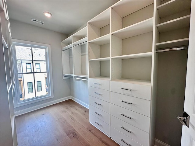 spacious closet featuring light wood-style floors and visible vents