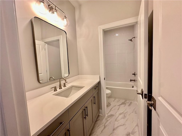 full bath featuring vanity, marble finish floor, shower / bathing tub combination, and toilet
