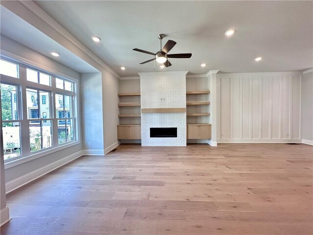 unfurnished living room with ornamental molding, a ceiling fan, recessed lighting, light wood finished floors, and baseboards