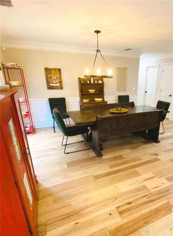 interior space featuring ornamental molding and light hardwood / wood-style flooring