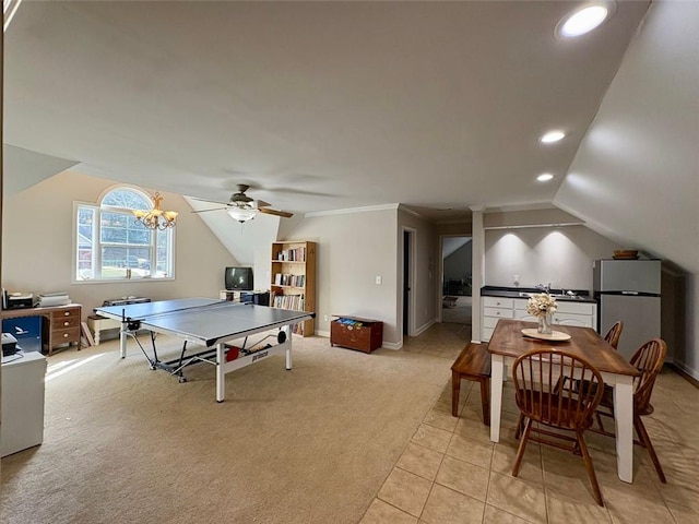 rec room featuring ornamental molding, vaulted ceiling, and light colored carpet