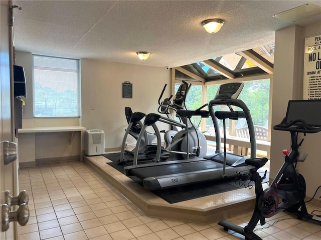 2285 Peachtree Rd NE Unit 1202, Atlanta, GA 30309 - exercise room featuring tile patterned floors and a textured ceiling