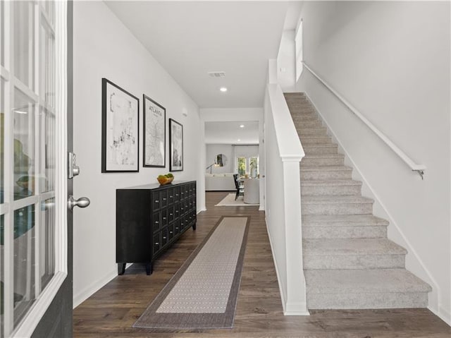 stairs featuring hardwood / wood-style floors