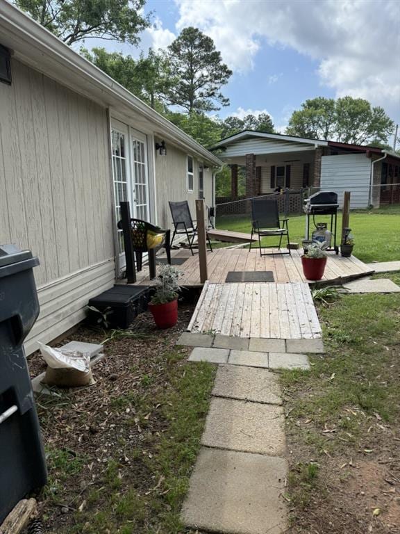 4282 By Pass, Loganville, GA 30052 - wooden terrace with a lawn, french doors, and grilling area