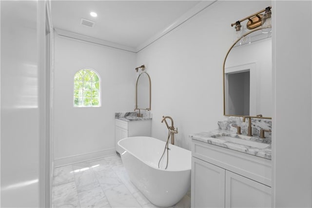 full bathroom featuring marble finish floors, a soaking tub, two vanities, baseboards, and ornamental molding
