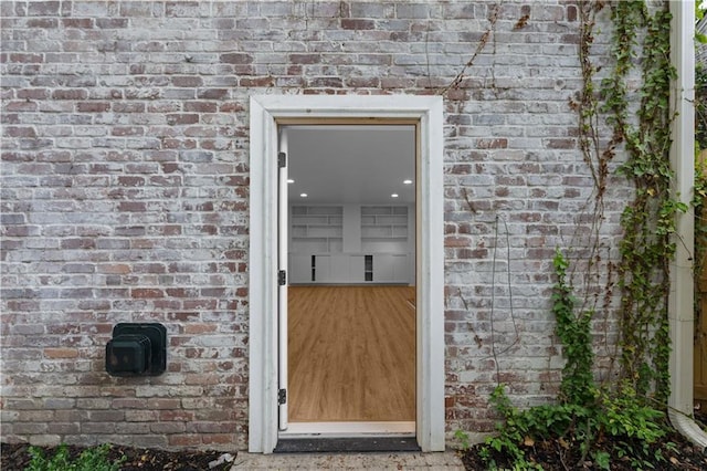 entrance to property with brick siding