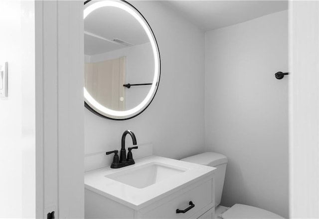 bathroom with toilet and vanity