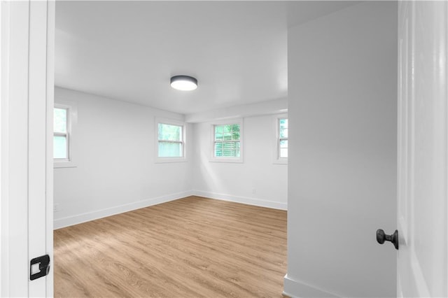 spare room featuring wood finished floors and baseboards