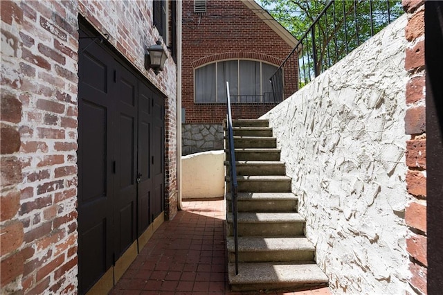 entrance to property featuring brick siding
