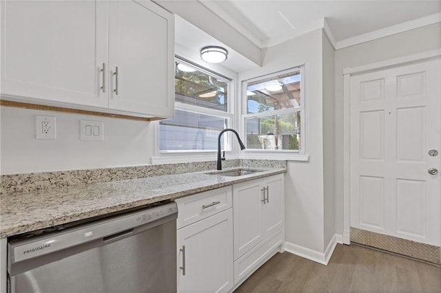 935 Bobcat Ct SE, Marietta, GA 30067 - kitchen featuring dishwasher, wood finished floors, white cabinetry, light stone countertops, and crown molding