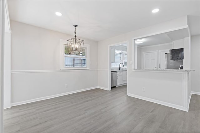 935 Bobcat Ct SE, Marietta, GA 30067 - unfurnished dining area featuring a chandelier, wood finished floors, and recessed lighting