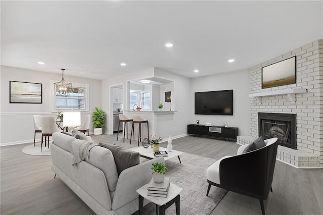 935 Bobcat Ct SE, Marietta, GA 30067 - living room with wood finished floors, a fireplace, a chandelier, and recessed lighting