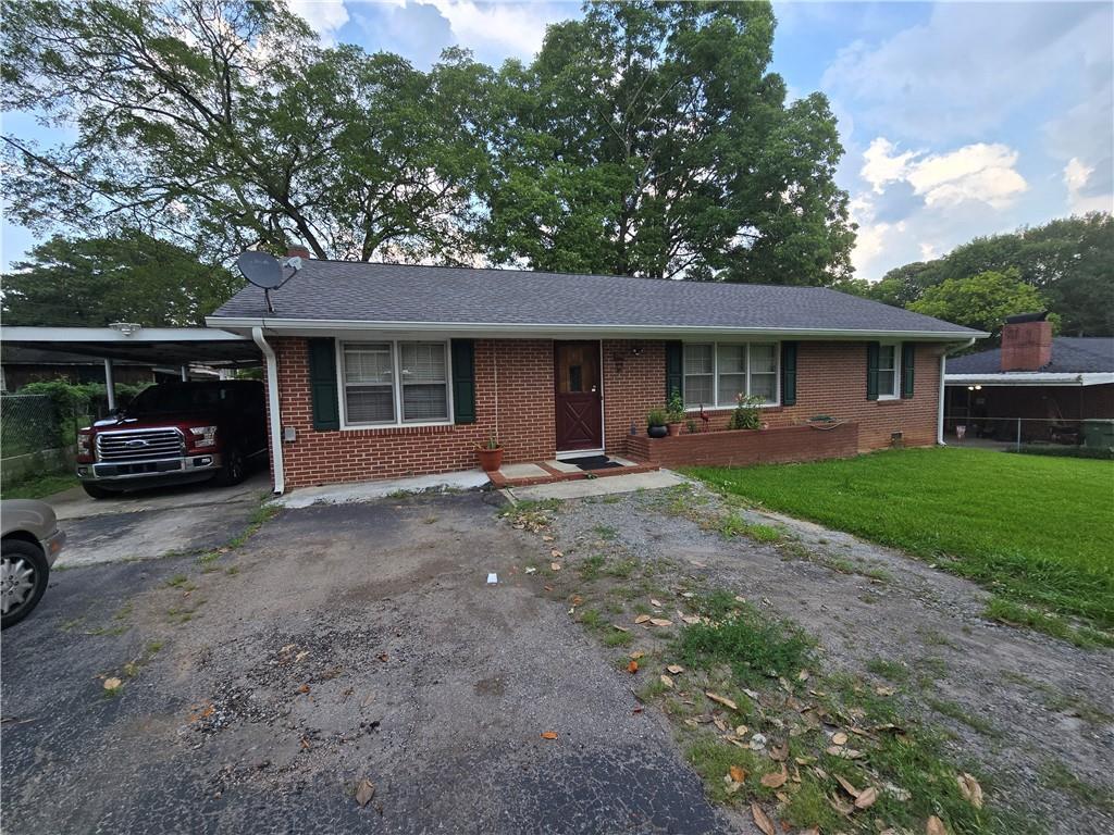 1763 Sandtown Rd SW, Marietta, GA 30060 - single story home featuring asphalt driveway, brick siding, and an attached carport