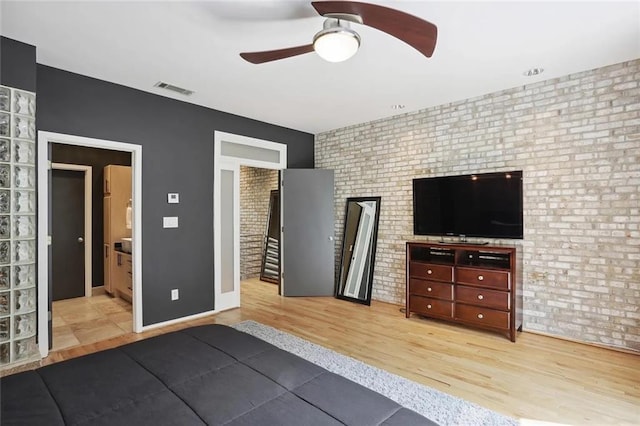 1323 Peachtree Vw NE, Atlanta, GA 30319 - bedroom featuring brick wall, wood finished floors, and ensuite bathroom