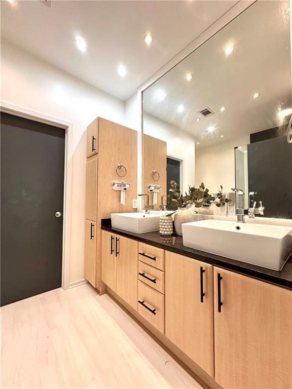 1323 Peachtree Vw NE, Atlanta, GA 30319 - full bath featuring wood finished floors, double vanity, and recessed lighting