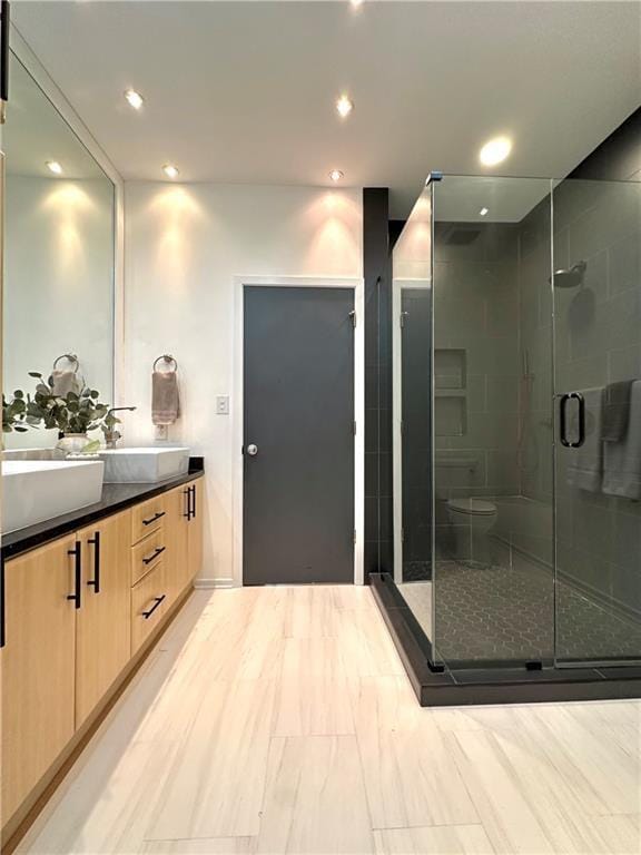 1323 Peachtree Vw NE, Atlanta, GA 30319 - bathroom featuring double vanity, a shower stall, and recessed lighting