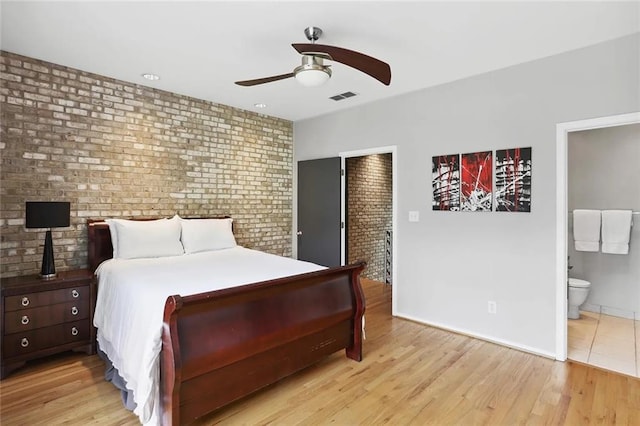 1323 Peachtree Vw NE, Atlanta, GA 30319 - bedroom with brick wall, wood finished floors, baseboards, ensuite bath, and a ceiling fan