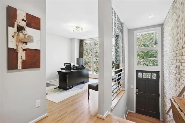 1323 Peachtree Vw NE, Atlanta, GA 30319 - entryway featuring healthy amount of natural light, wood finished floors, a desk, baseboards, and brick wall