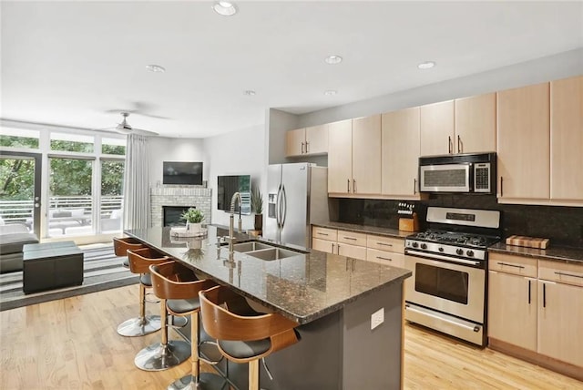 1323 Peachtree Vw NE, Atlanta, GA 30319 - kitchen with appliances with stainless steel finishes, backsplash, light brown cabinets, dark stone counters, and recessed lighting
