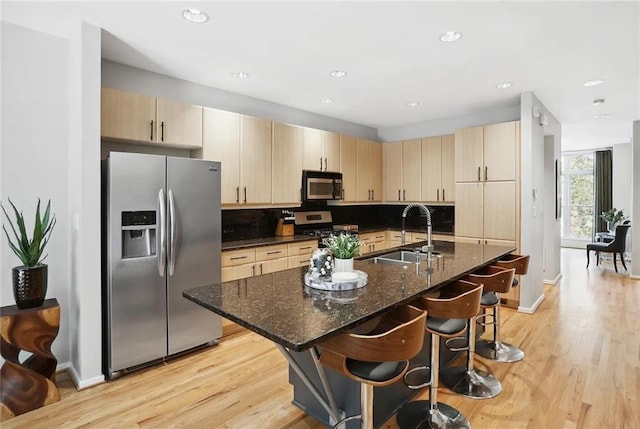 1323 Peachtree Vw NE, Atlanta, GA 30319 - kitchen with appliances with stainless steel finishes, a sink, baseboards, a breakfast bar area, and recessed lighting