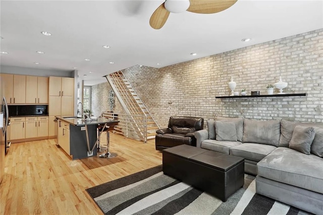 1323 Peachtree Vw NE, Atlanta, GA 30319 - living area with brick wall, ceiling fan, light wood-style floors, recessed lighting, and stairs