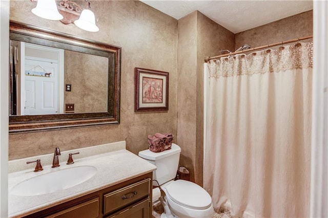 bathroom featuring walk in shower, vanity, and toilet