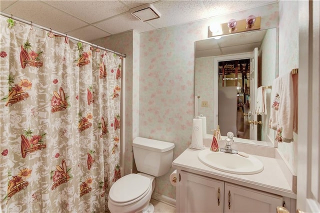 bathroom featuring vanity, a paneled ceiling, and toilet