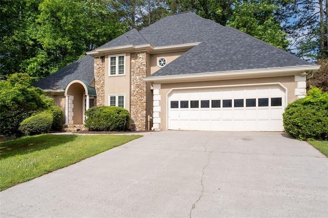 1593 Brynwood Ct NW, Acworth, GA 30101 - traditional-style house featuring a garage, driveway, roof with shingles, and stone siding