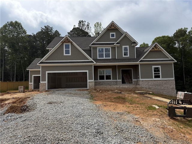 1081 Holly Dr, Loganville, GA 30052 - craftsman-style house featuring driveway, brick siding, fence, and roof with shingles