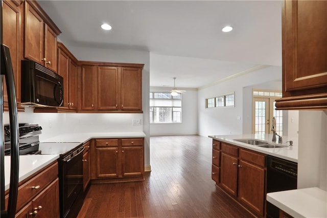 1585 Oak Meadows Ln, Cumming, GA 30041 - kitchen with black appliances, dark wood-style flooring, ceiling fan, light countertops, and recessed lighting