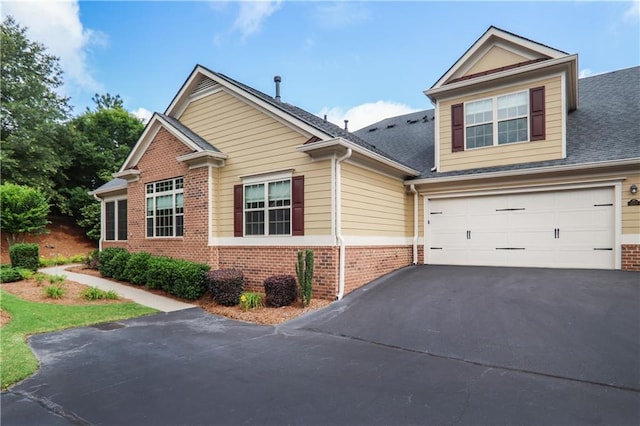 1585 Oak Meadows Ln, Cumming, GA 30041 - craftsman inspired home featuring brick siding, driveway, a garage, and roof with shingles