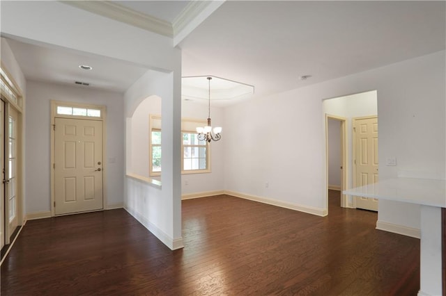 1585 Oak Meadows Ln, Cumming, GA 30041 - entryway featuring a chandelier, dark wood finished floors, crown molding, and arched walkways