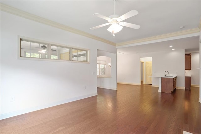 1585 Oak Meadows Ln, Cumming, GA 30041 - unfurnished living room with a ceiling fan, crown molding, dark wood-type flooring, and arched walkways
