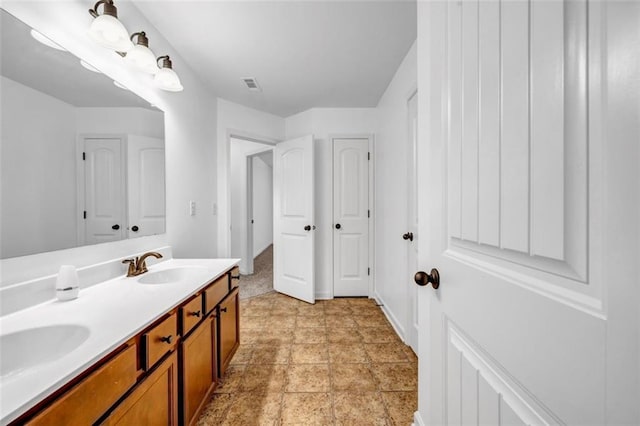 7601 Watson Cir, Locust Grove, GA 30248 - bathroom featuring double vanity and baseboards